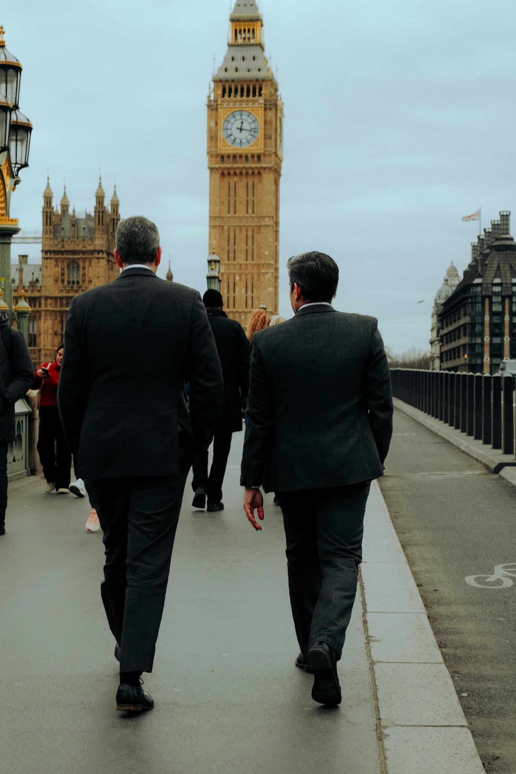 Two legal professionals walking across Westminster Bridge